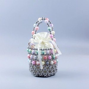 Close-up of handmade beaded bucket bag with satin drawstring liner and marble texture beads