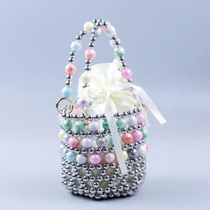 Detail of handmade beaded bucket bag with marble resin beads and satin drawstring liner