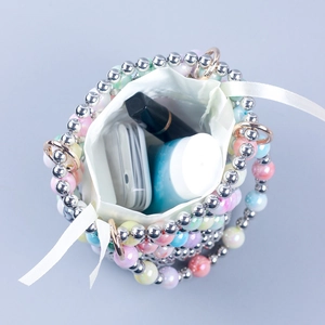 Handmade beaded bucket bag with drawstring silk pouch showing interior capacity and beads