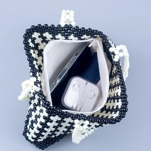 Handmade black and white checkered beaded handbag with zipper closure and spacious interior