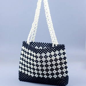Handmade black and white beaded clover tote bag with elegant floral woven patterns