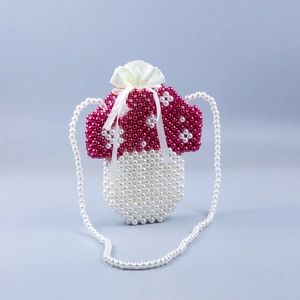 Detail of handmade beaded mushroom bag with red white dots and drawstring closure
