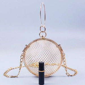 Detail of golden spherical hollow cage clutch bag with ring handles and fine chain strap