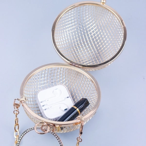 Golden spherical metal mesh evening bag with rhinestone ring handle and chain strap