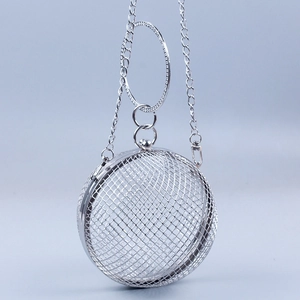 Detailed view of silver hollow mesh ball bag with rhinestone handle and chain strap