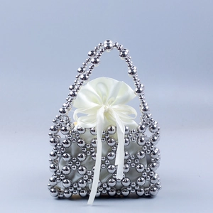 Handmade silver beaded tote bag with a white satin drawstring pouch and bow decoration