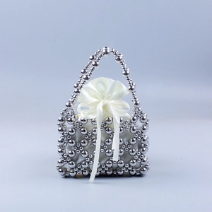 Silver beaded basket handbag with white satin drawstring pouch and hollow woven design