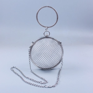 Detail of silver spherical metal mesh clutch with rhinestone-studded ring handle