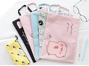 Flat lay of colorful A4 document bags with cute pig designs and zipper closure