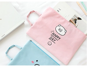 Close-up of pink canvas document bag with cute cartoon pig and Happy Day print