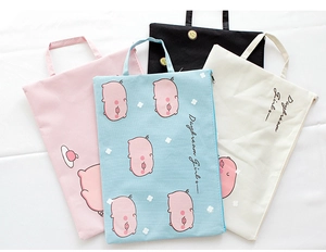 Detail of four colorful canvas document bags with pig prints and zipper closure