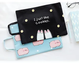 Detail of canvas document bags with zip closure and cartoon prints for iPads or A4 files