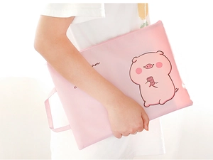 Pink cartoon pig canvas A4 document bag with zipper and handle held by model