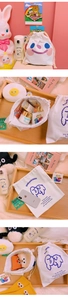 Detailed close-up of cotton drawstring bags featuring cute dog and smiley face illustrations