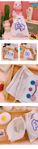 Detail of white canvas drawstring storage bag with cute puppy print and sturdy cotton rope