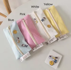 Minimalist macaron canvas pencil cases in pastel colors with cute cartoon badges