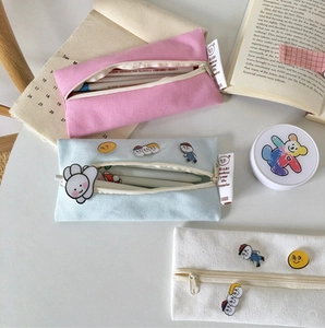 Cute macaron color canvas pencil cases in pink, blue, and white with cartoon patches