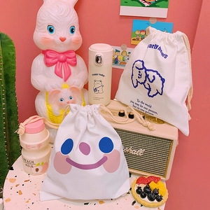 White canvas drawstring storage bags featuring cute cartoon smile and poodle designs