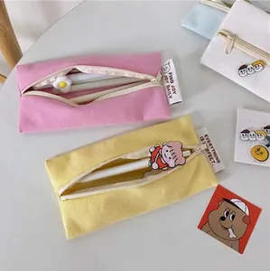 Creative macaron color canvas pencil cases for students with cute charms and zipper closure