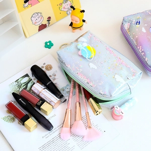 Detail of laser iridescent makeup bag with glitter sequins and white cloud patches