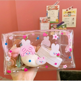 Transparent PVC makeup bag with cute rabbit prints held in hand showing capacity
