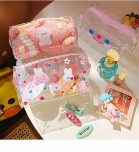 Detail of waterproof clear PVC cosmetic bags with cute cartoon prints and pink zippers