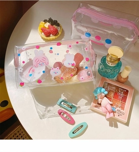 Transparent PVC cosmetic bag with cartoon prints showing large storage capacity and items