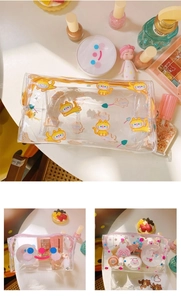 Macro view of clear PVC makeup bag showing cute cartoon prints and sturdy zipper closure