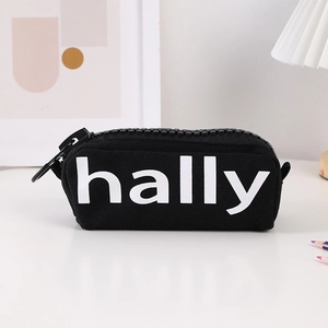 Detail of black canvas pencil case with oversized plastic zipper and hally logo