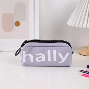 Detail of lavender canvas pencil case with chunky black zipper and hally logo
