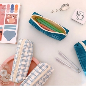 Top view of plaid canvas pencil case showing large capacity on a desktop