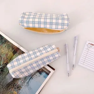 Detail of blue sea salt plaid pencil case with canvas texture and yellow lining