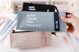 Close-up of minimalist PU leather pencil case with zipper and white letter print