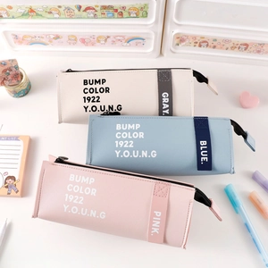 Detailed view of pastel PU leather pencil cases with metal zippers and color-coded labels