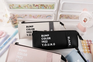 Detail of colorful PU leather pencil cases with BUMP COLOR print and metal zippers