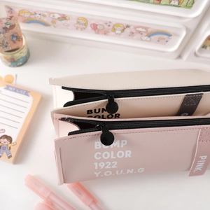 Close-up of double-zipper PU leather pencil case showing large storage space and texture