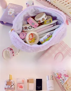 Detail of purple plush makeup bag showing spacious interior for cosmetics and stationery