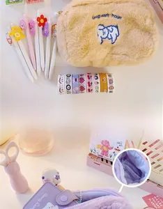Detailed view of plush makeup bag with cute embroidery and interior storage space