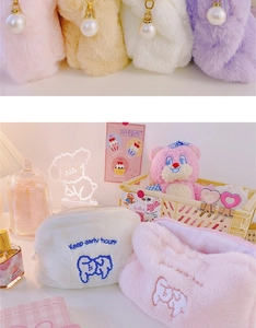 Detail of plush cosmetic bag with bear embroidery and pearl zipper pull in pastel colors