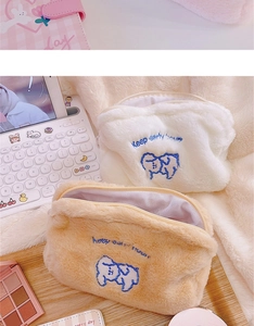 Plush makeup bags in cream and light brown with dog embroidery and zipper closure