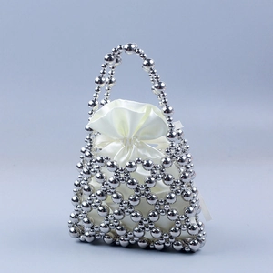 Detail of silver beaded hollow bag with a smooth white satin drawstring inner pouch