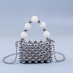 Detailed close-up of handmade silver beaded mini bag with elegant pearl chain handle