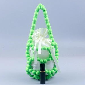 Handmade green beaded bucket bag with white satin drawstring lining and sleek woven design