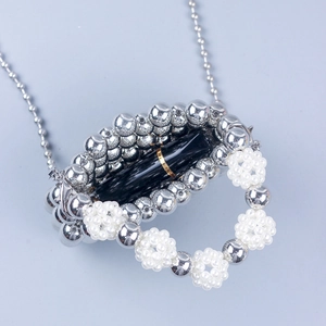 Handmade beaded mini crossbody bag with silver pearls and a sleek metal chain strap