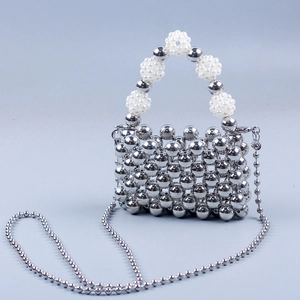 Detail of handmade silver beaded crossbody bag with pearl cluster handle and chain strap
