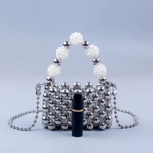 Mini silver beaded handbag with pearl strap and lipstick for scale comparison