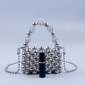 Silver beaded mini crossbody bag with pearl chain and metallic woven handle design