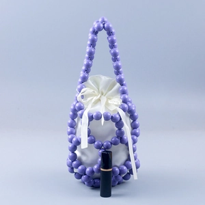 Handmade purple beaded bucket bag with white satin drawstring liner and ribbon bow detail