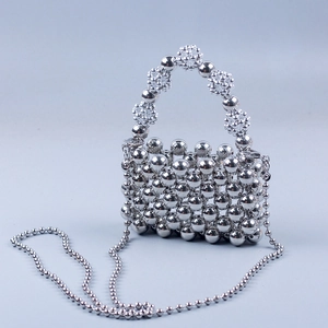 Detailed view of handcrafted silver metallic beaded mini bag with floral pearl handle and chain