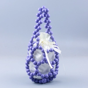 Detailed shot of purple beaded bucket bag with white satin drawstring liner